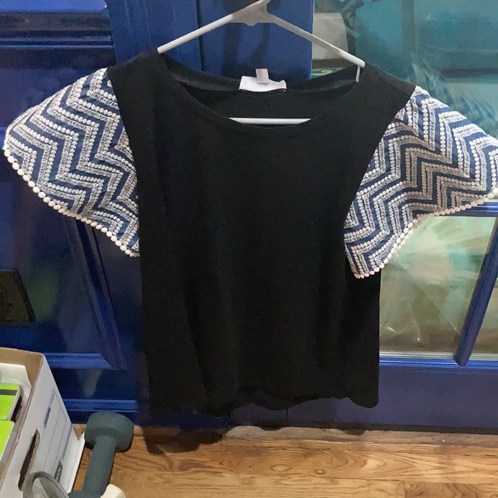 Black tee with blue and white ruffle sleeves